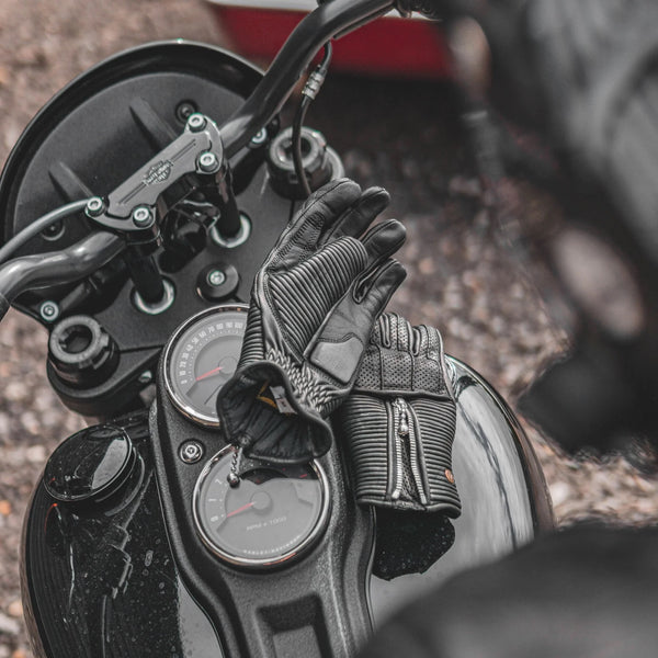 Goldtop raptor women's gloves black on motorcycle tank