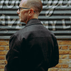 model wearing the black twill motorcycle jacket - back detail