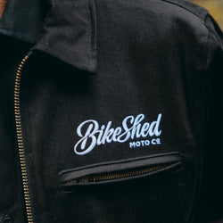 detail of the Bike Shed Moto logo on our black twill motorcycle jacket