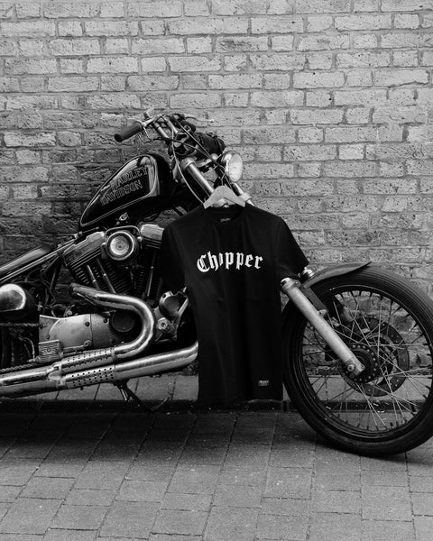 BSMC Chopper T-Shirt - Black hanging from a chopper motorcycle