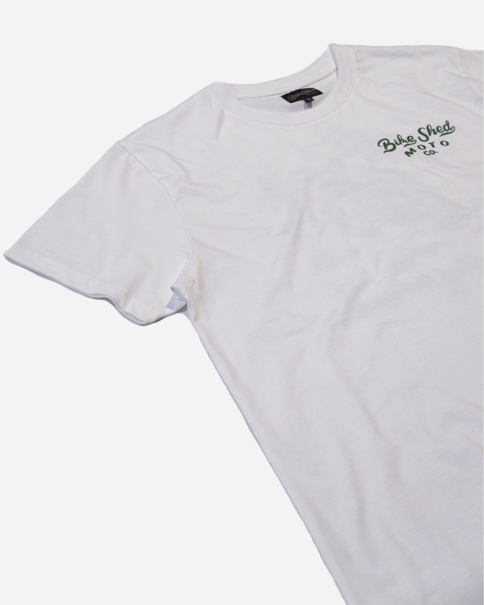 White t-shirt with dark green Bike Shed Moto Co text logo on a white background
