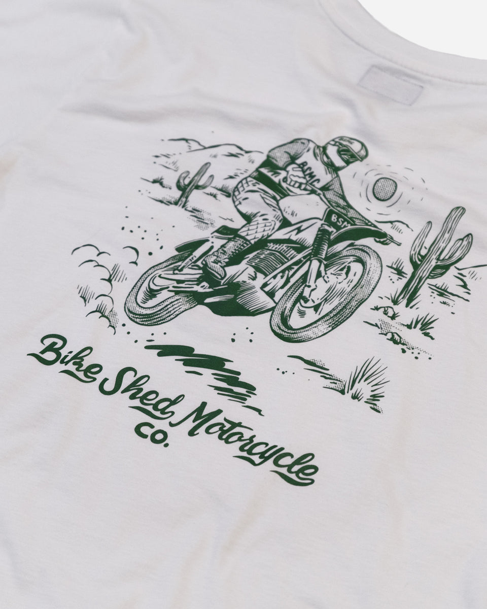 White t-shirt with green motorcycle graphic and 'Bike Shed Motorcycle Co.' text logo on a white background