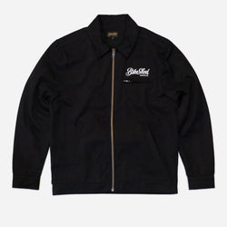 Black twill motorcycle jacket with a Bike Shed Moto Co brand logo on a white background