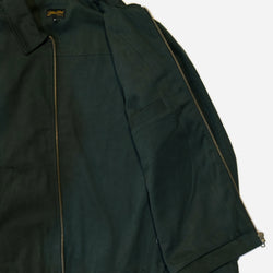 Dark green motorcycle jacket with a Bike Shed Moto Co brand logo on a white background
