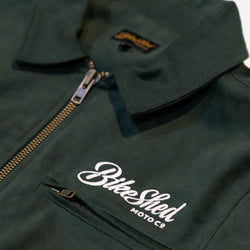 Green motorcycle jacket with 'Bike Shed Moto Co' logo on a white background
